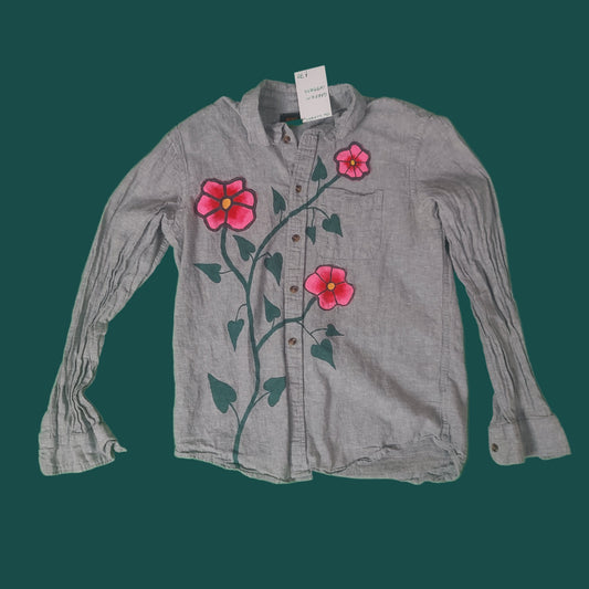 Gray shirt with pink floral designs on a green background